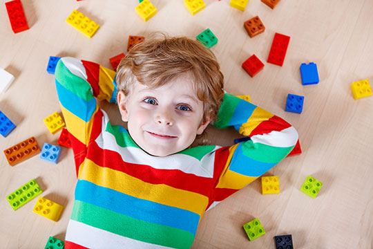 Small boy surrounded by colorful blocks