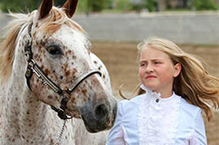 Blonde girl with appaloosa horse