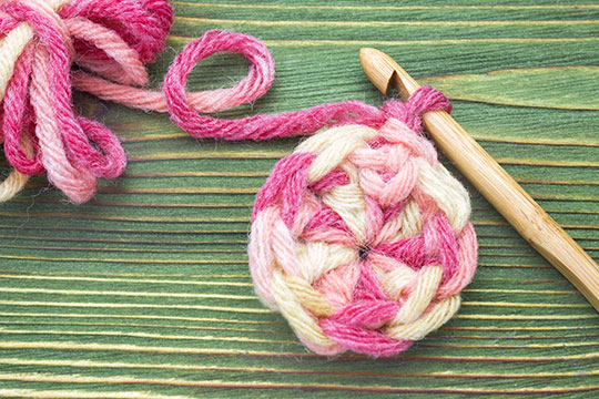 pink and white yarn with hook