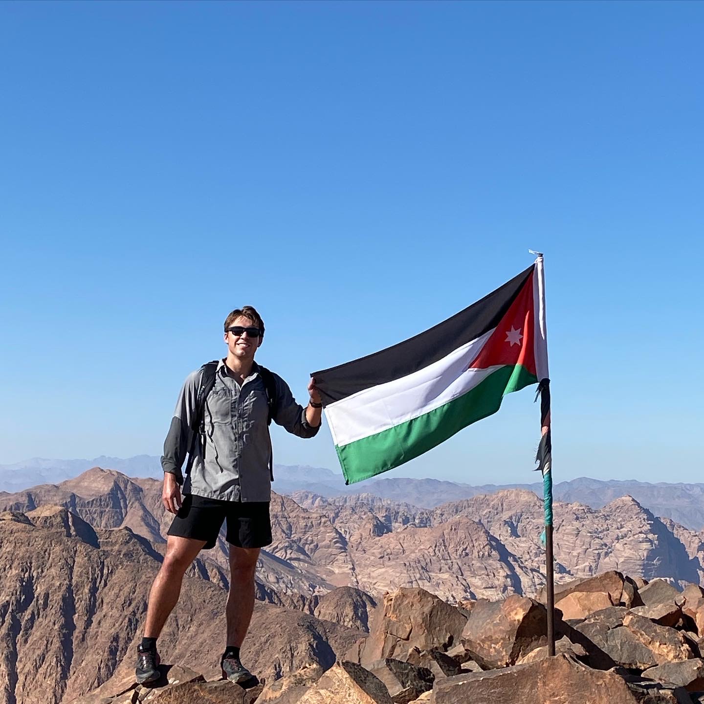 Mat Waugh standing next to Jordanian flag