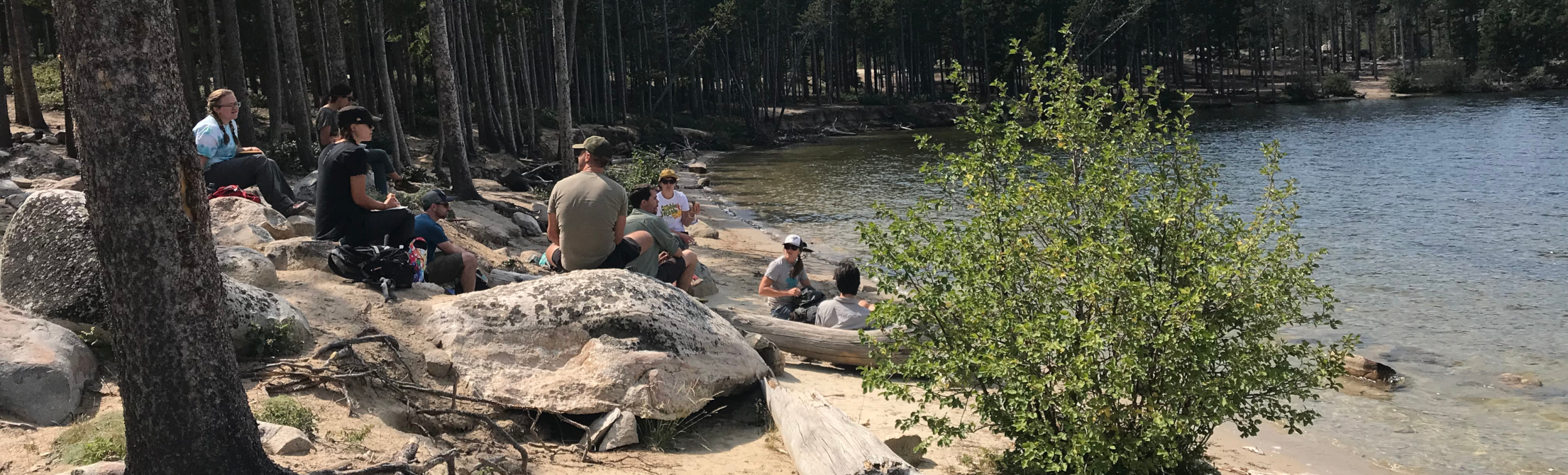 Program in Ecology students relaxing by a lake at the 2019 PiE Odyssey