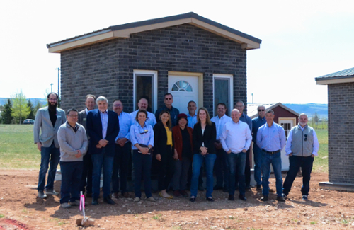 Members of the Peabody leadership team pose outside the char brick demonstration house along with me