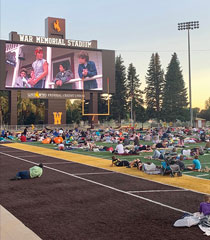 people watching a movie on a football field
