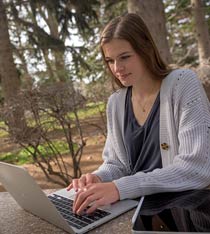woman using a laptop computer outside