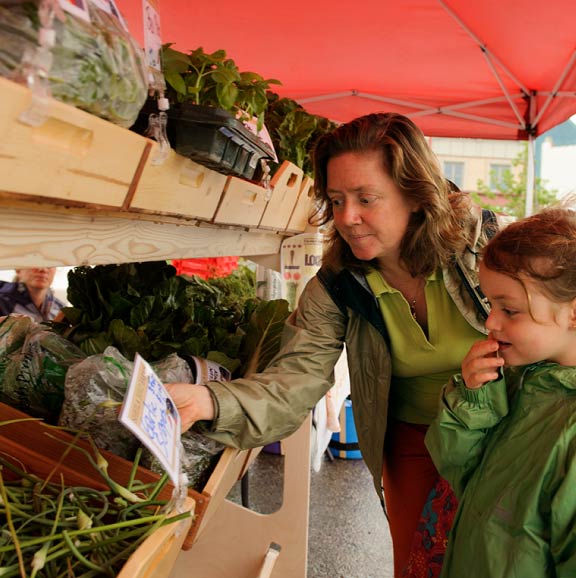 A woman and her daughter select fresh produce at the Farmer's Market in Laramie.