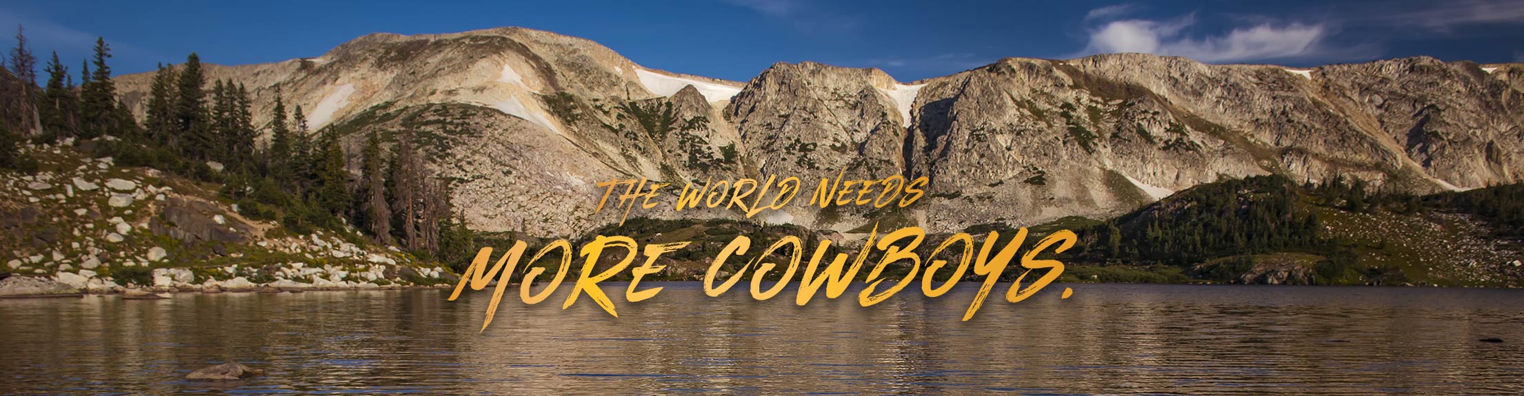 The World Needs More Cowboys over a scenic mountain photo