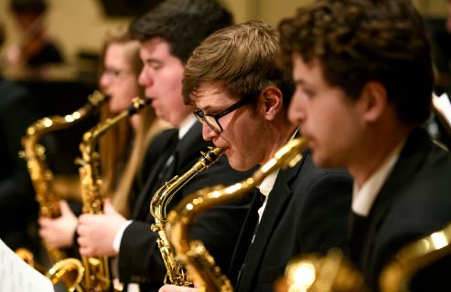 A group of students play saxophone at a UW music performance.