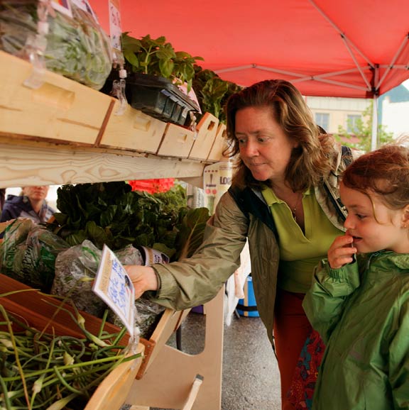 A mother and daughter select fresh produce from Student ACRES Farm