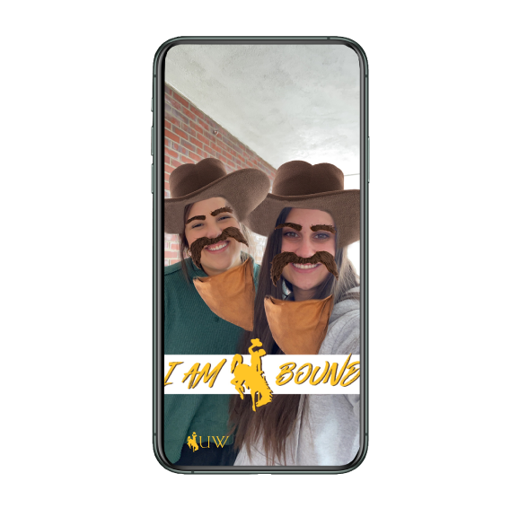 A phone with two students using  he UW Signing Day SnapChat lens