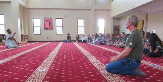 Shawn kneeling in a mosque