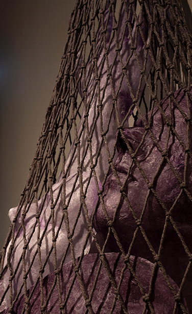 detail image of ceramic figure in netting