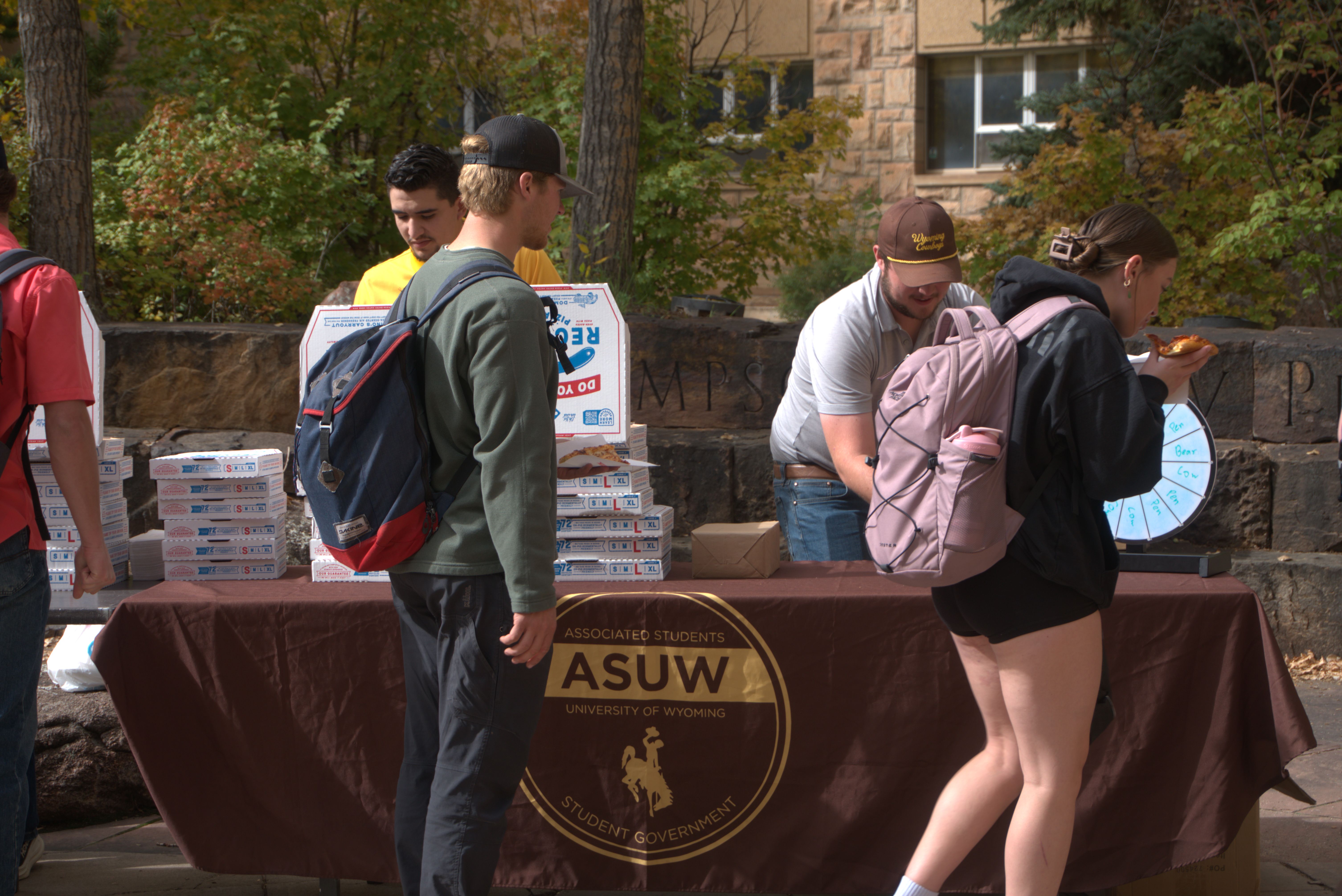 A cute black dog wearing the ASUW homecoming T-Shirt