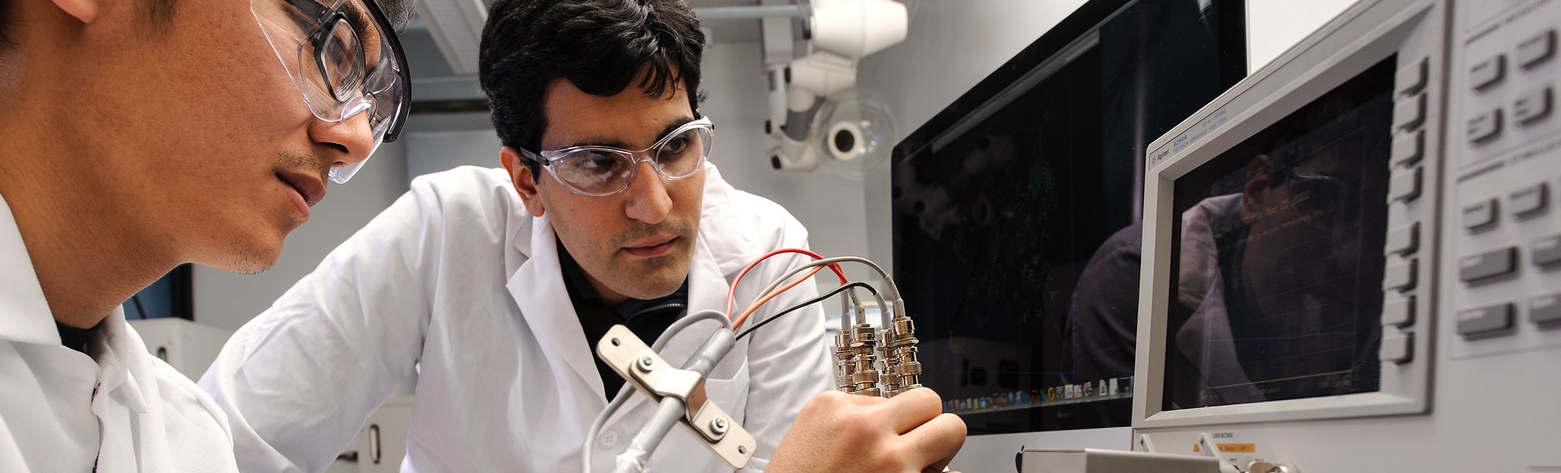 Petroleum engineering graduate students study pore-scale models.