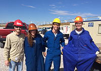 A group of mechanical engineering students pose at an industry work site.