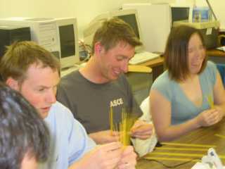 students laughing while building bridge
