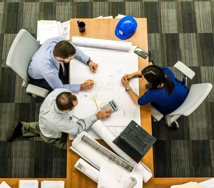 Group of people planning a project around a table.