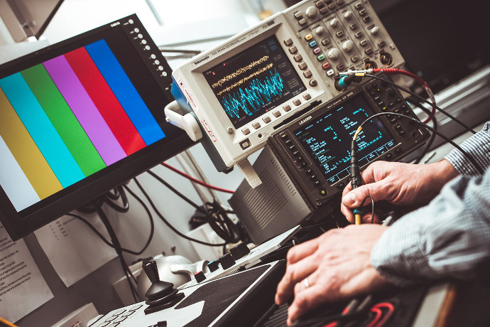 Engineer using an oscilliscope.