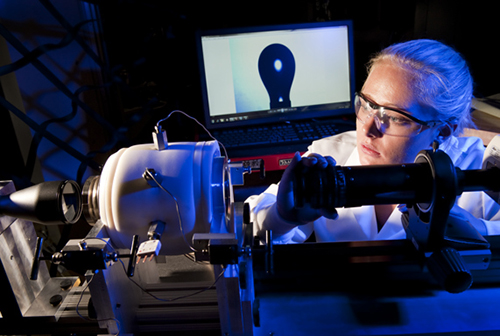 A female chemical engineering student in a blue light of the lab