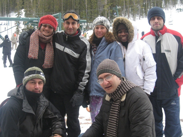 Research group posing for camera in the snow