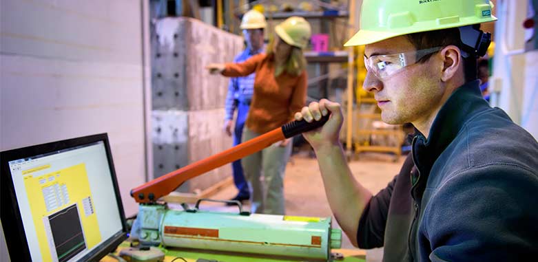 Student in hard hat controlling pressure lever