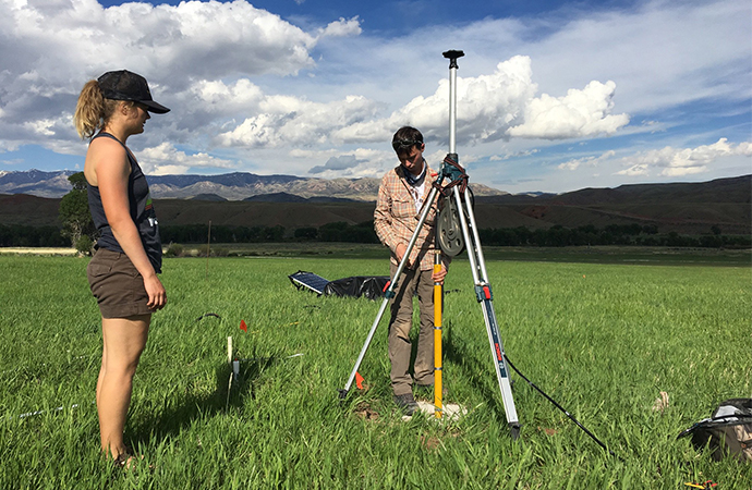 Civil engineering students test groundwater using meters.
