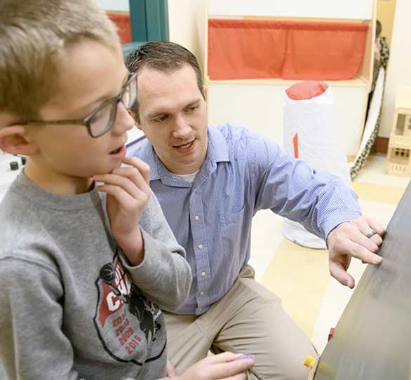 Counselor student working with child