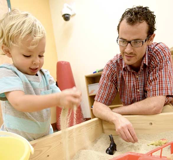 Counselor student in play therapy with child