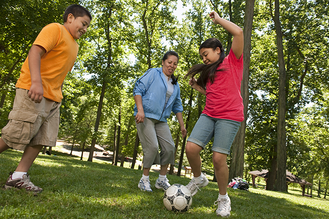 Image of family playing soccer. 