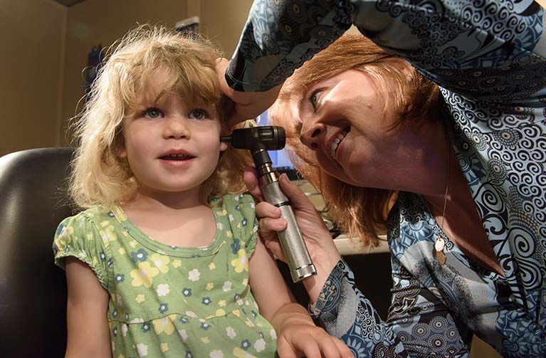 Child being examined by a hearing specialist. 