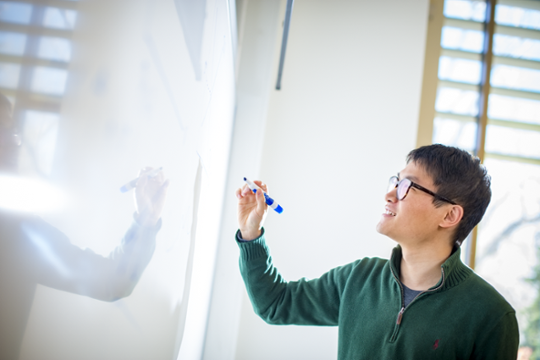 GTA teaching with whiteboard in classroom