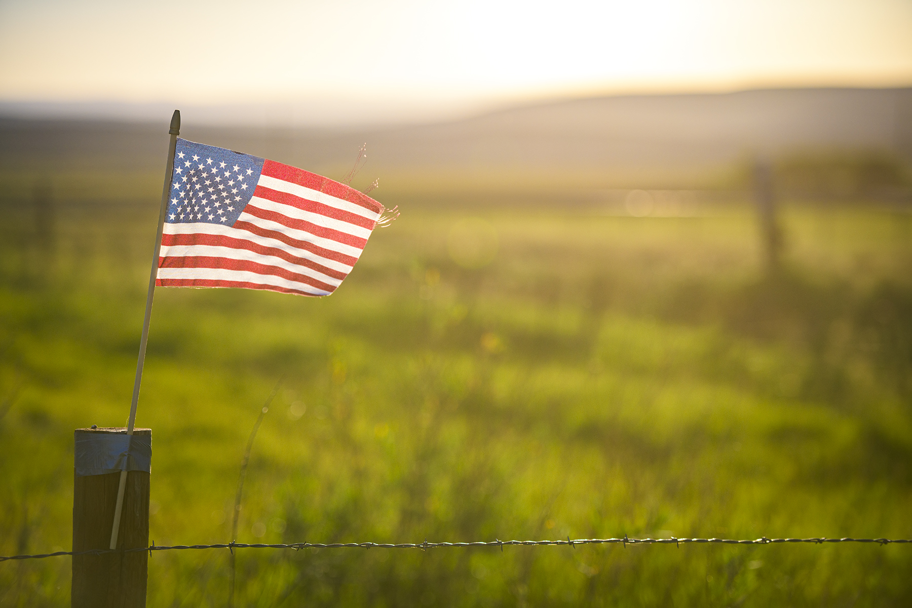 American flag in front of field