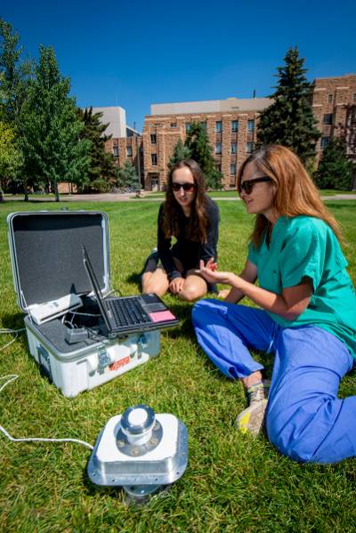 Graduate Student and Faculty Member Collecting Data