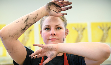 art student shows her ink-stained hands
