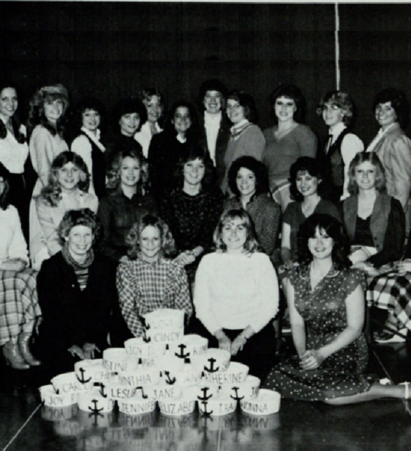 Group photo of Delta Gammas with sailor hats stacked in a pyramid in front