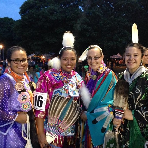 Four members of Alpha Pi Omega in traditional native America outfits 