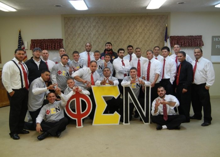 Members of Phi Sigma Nu with large wooden fraternity letters