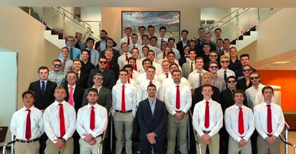 Members of the fraternity during the instillation of their chapter, all dressed in white shirts and red ties.
