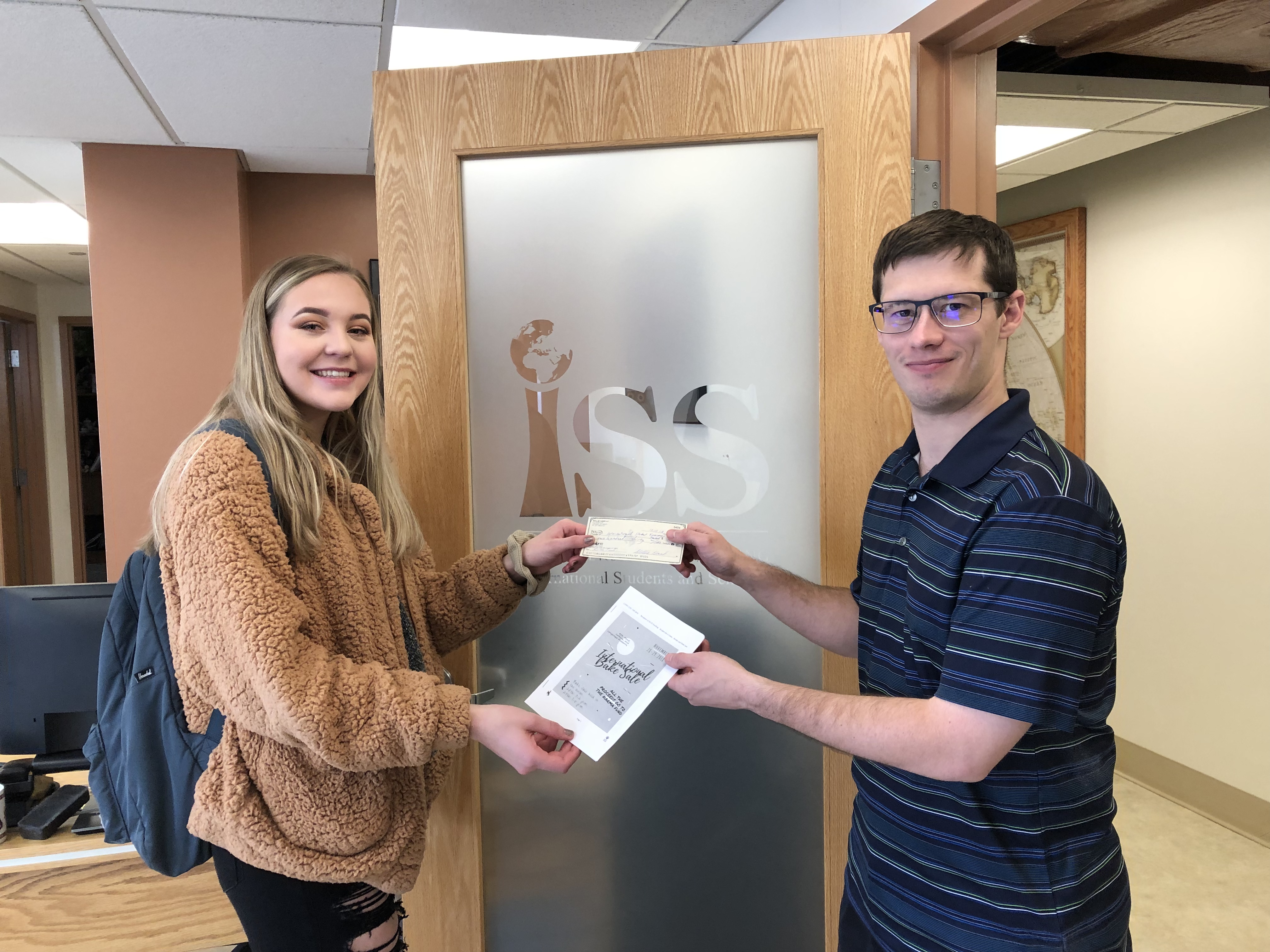 2018 student presents a check to Karma Fund