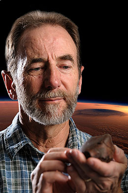 Kevin Chamberlain, a research professor at UW, examines a rock sample