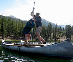 Two men working from a canoe