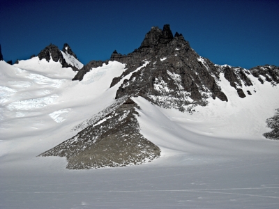 snow covered mounatins with rocky peak 