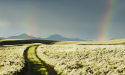 Dirt road with a rainbow in the sky