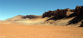 Desert environment displaying sedimentary rocks.
