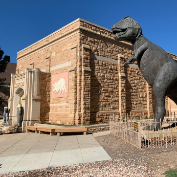 picture of ourside museum and trex statue