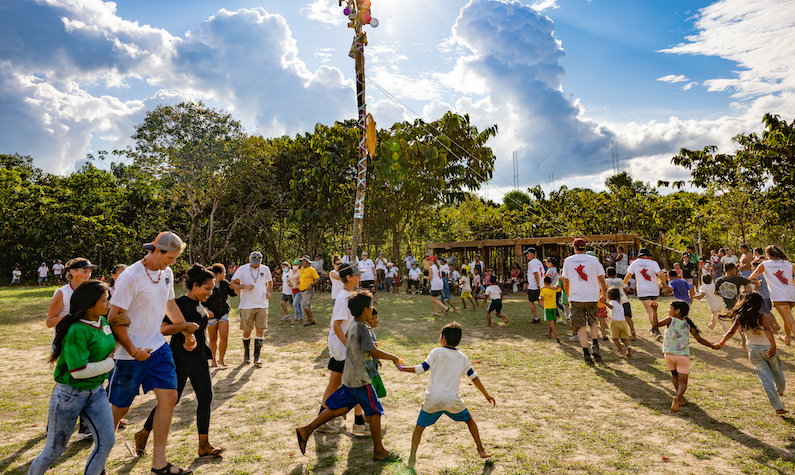Children and volunteers celebrating a festival in Peru