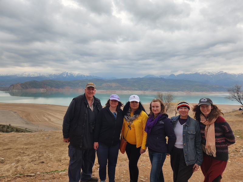 tour group in front of a lake and mountains