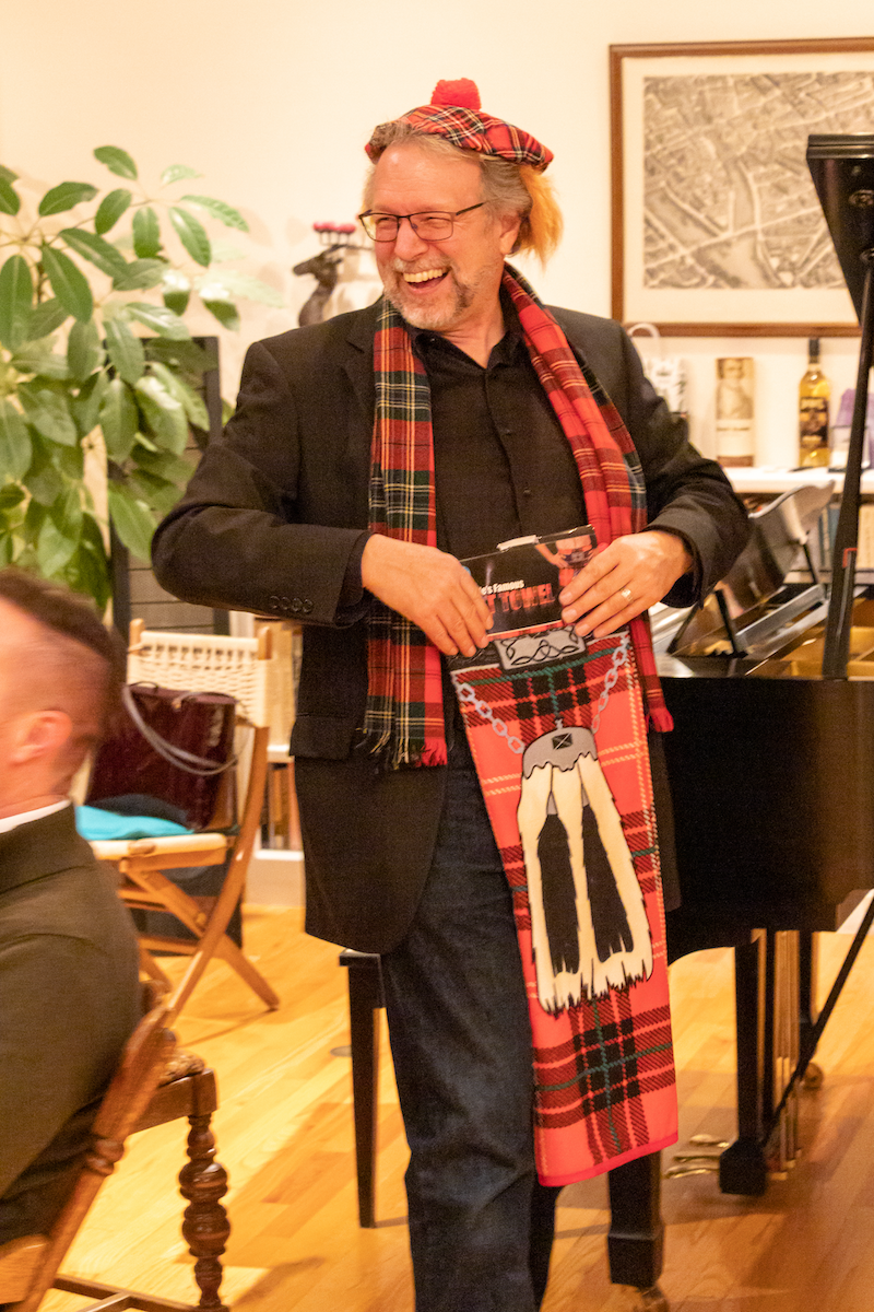 Paul Flesher showing off a tartan outfit for a fundraiser