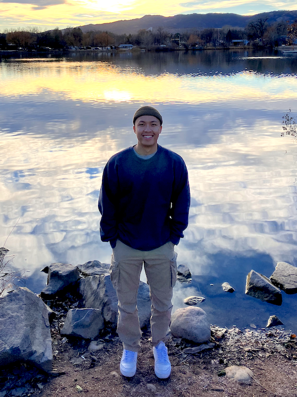 Muhammad Sulthon smiling at camera in front of a lake