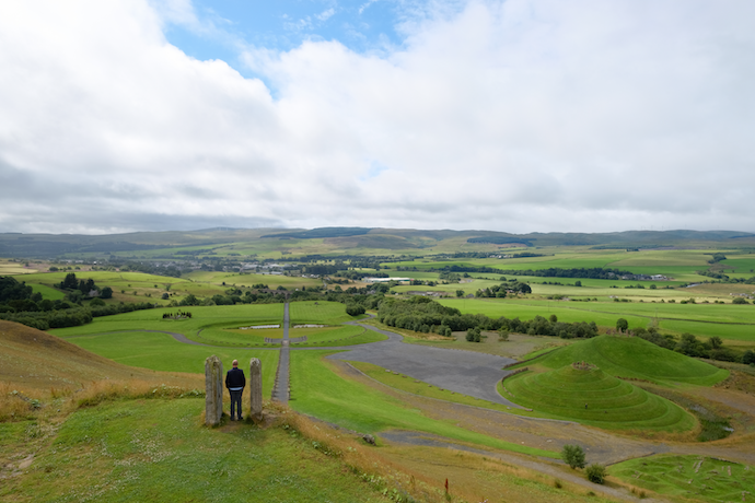 man standing over Scottish landscape, by Robby Bishop