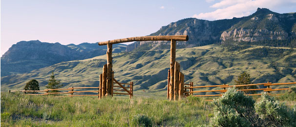 Ranch entrance in front of mountains